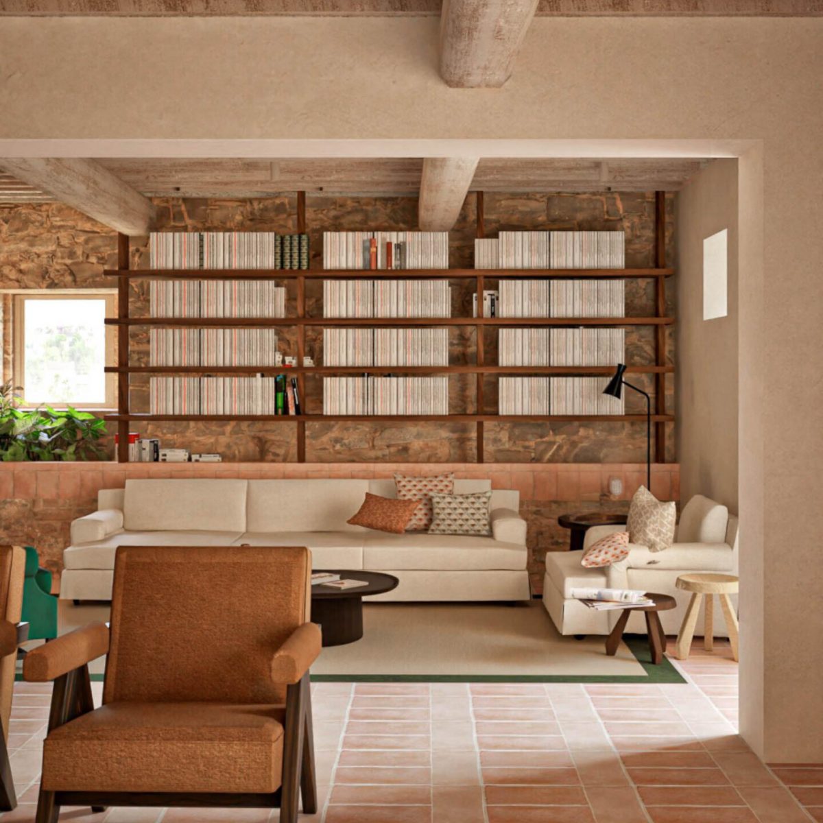 Interior of the farmhouse library on the 173-acre Agaporia estate, warm stone walls and receding shelves of books. The Beating Heart of The Conscious Club at the regenerative five-star sanctuary in Tuscany.