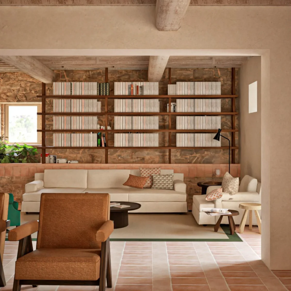 Interior of the farmhouse library on the 70-hectare Agaporia estate, warm stone walls and receding shelves of books. The Beating Heart of The Conscious Club at the regenerative five-star sanctuary in Tuscany.