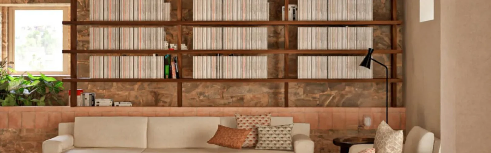 Interior of the farmhouse library on the 70-hectare Agaporia estate, warm stone walls and receding shelves of books. The Beating Heart of The Conscious Club at the regenerative five-star sanctuary in Tuscany.