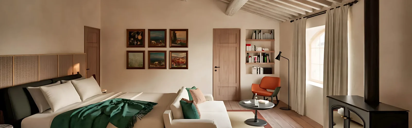 Interior of a 65m² Sovereign Sanctuary at Agaporia opening onto the Tuscan landscape through expanded glazing, with reclaimed chestnut surfaces and lime-plaster walls.